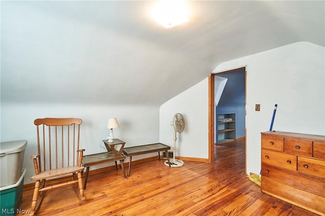 living area with lofted ceiling and light hardwood / wood-style flooring