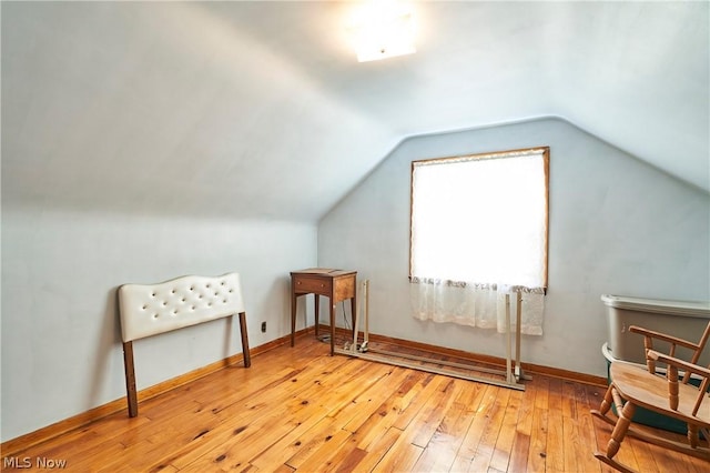 additional living space featuring light hardwood / wood-style flooring and vaulted ceiling