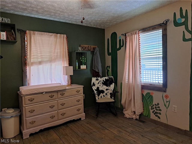 bedroom featuring a textured ceiling and hardwood / wood-style flooring