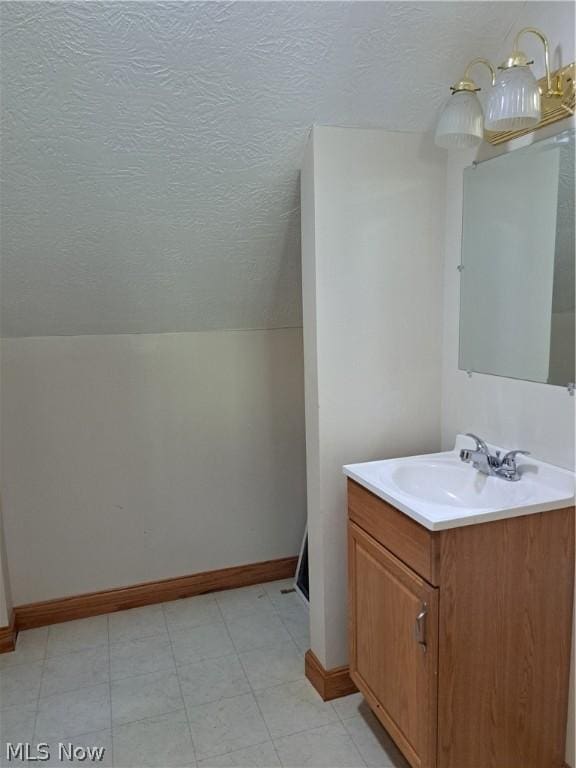 bathroom featuring vanity and vaulted ceiling