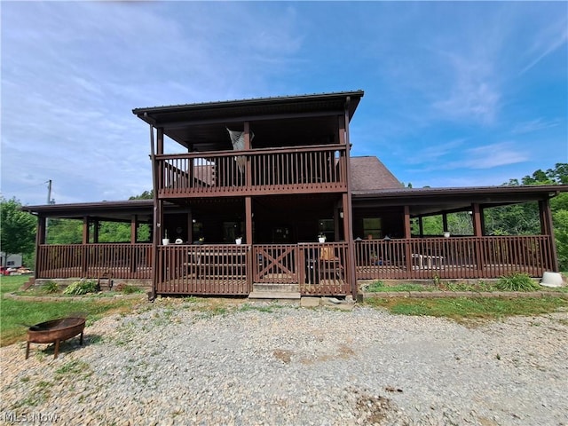 view of front of property featuring a wooden deck and a fire pit