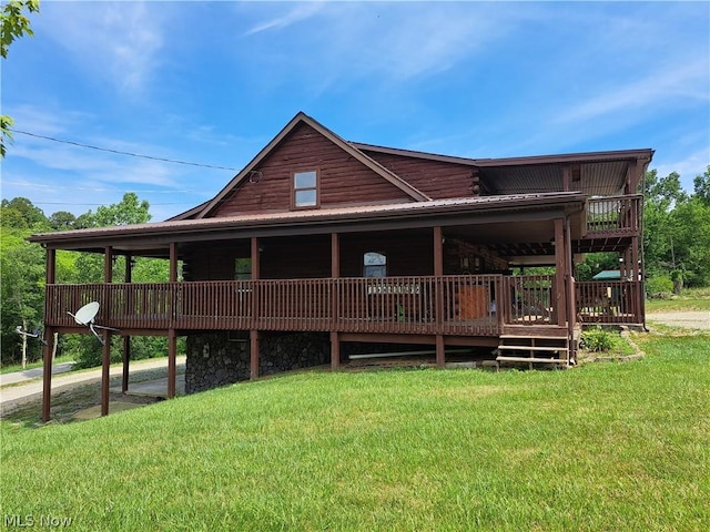 rear view of property featuring a lawn and a deck