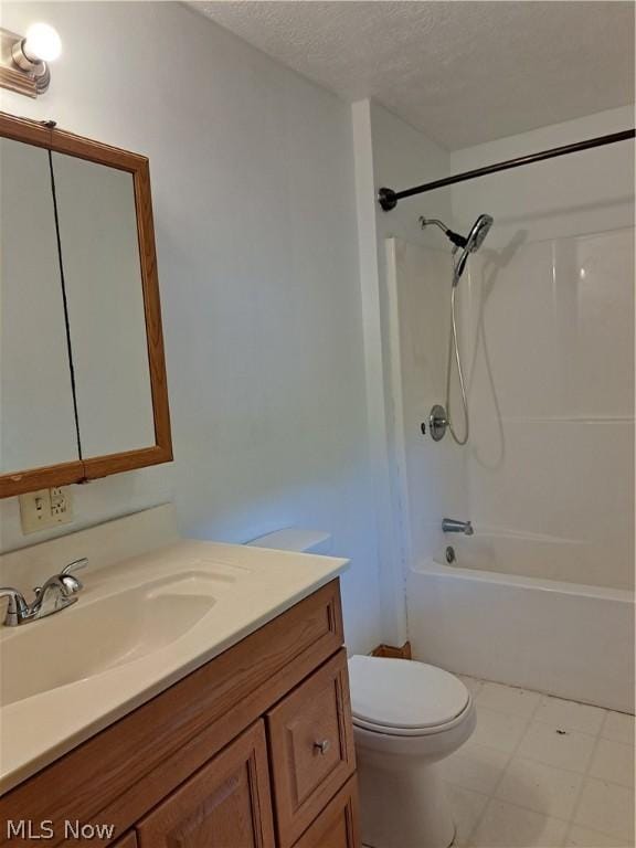 full bathroom with bathing tub / shower combination, vanity, a textured ceiling, and toilet