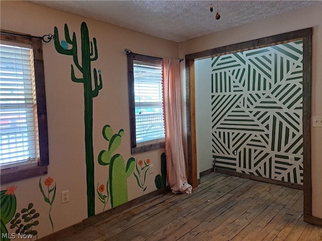 interior space featuring a textured ceiling and hardwood / wood-style flooring