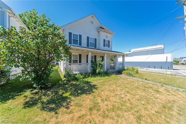 view of front of property featuring covered porch and a front lawn