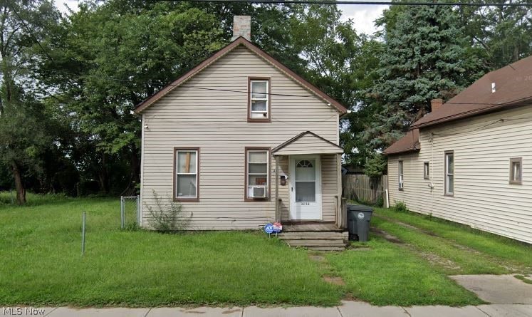 bungalow-style home with a front lawn