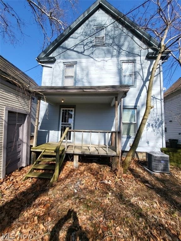 rear view of house featuring covered porch and central AC