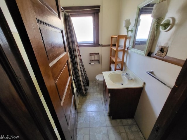 bathroom featuring vanity and toilet