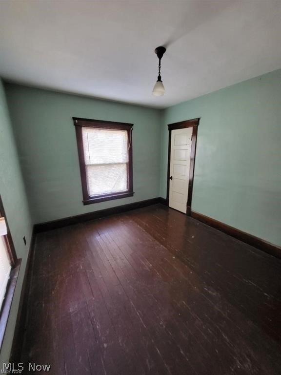 unfurnished room featuring dark hardwood / wood-style floors