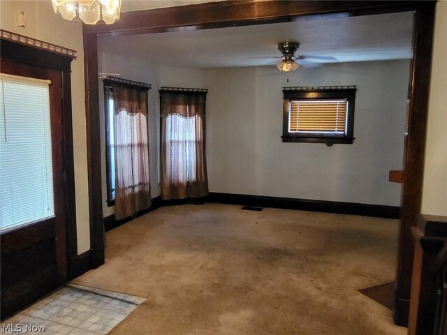 unfurnished room featuring light carpet and ceiling fan