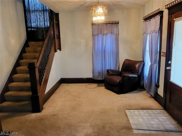 living area with light colored carpet and a notable chandelier