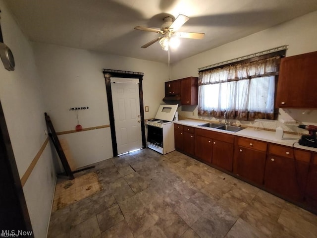 kitchen with white range with electric stovetop, ceiling fan, and sink