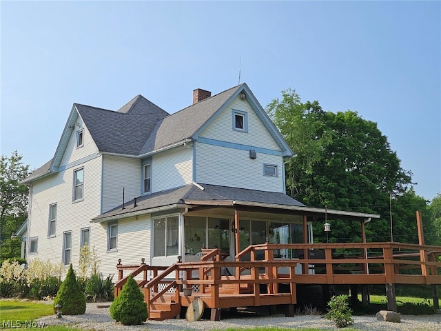 rear view of house featuring a deck