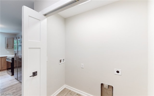 clothes washing area with hookup for a washing machine, hookup for an electric dryer, and light hardwood / wood-style floors