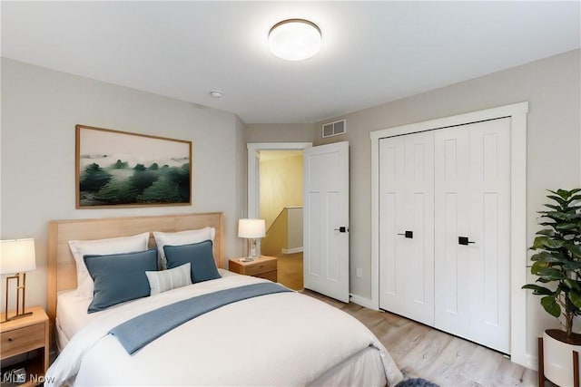 bedroom featuring light hardwood / wood-style flooring and a closet