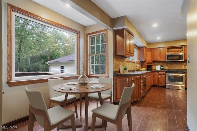 kitchen featuring appliances with stainless steel finishes, sink, and tasteful backsplash