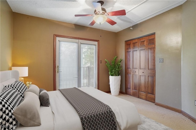 bedroom featuring ceiling fan, light colored carpet, and a closet