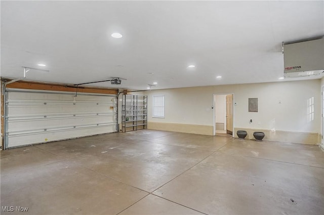 garage with a garage door opener and electric panel