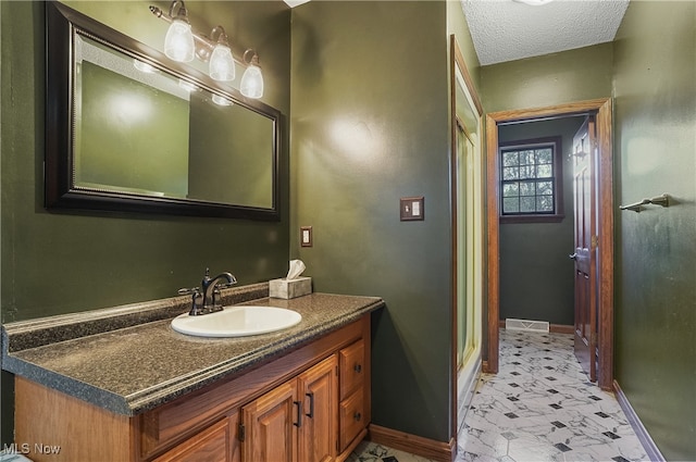 bathroom featuring vanity and a textured ceiling