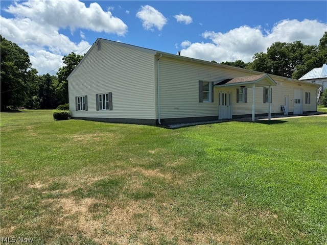 view of side of home featuring a lawn