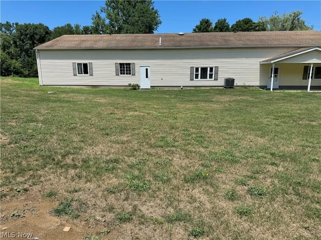 rear view of house with a yard