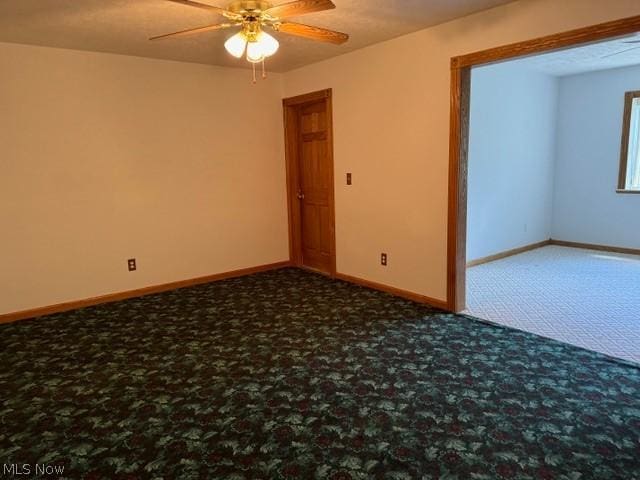 empty room featuring carpet floors and ceiling fan