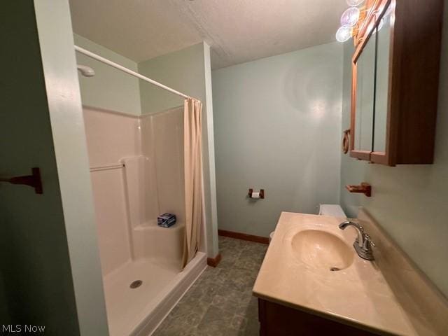 bathroom with vanity and walk in shower