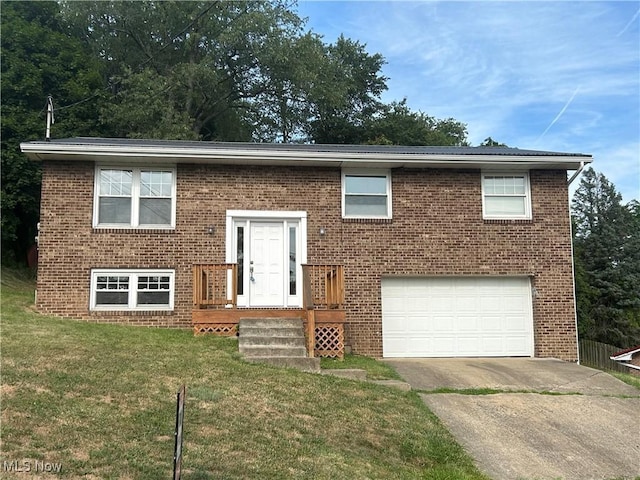 bi-level home with driveway, brick siding, and a front lawn