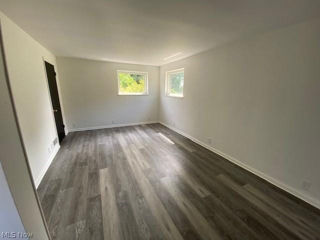 empty room featuring dark hardwood / wood-style flooring