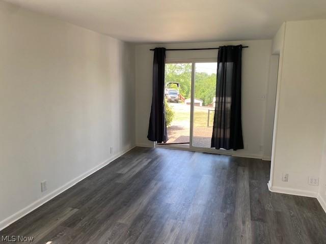 empty room featuring dark wood-type flooring