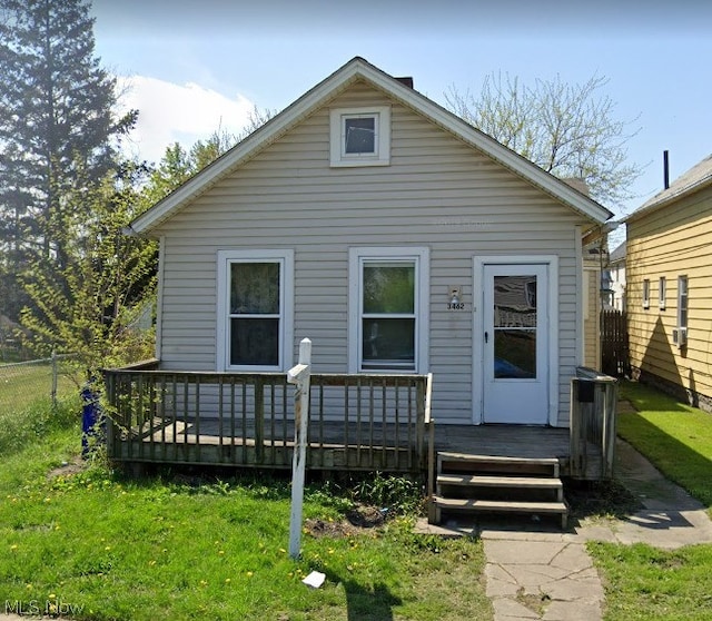 bungalow featuring a front yard and a deck