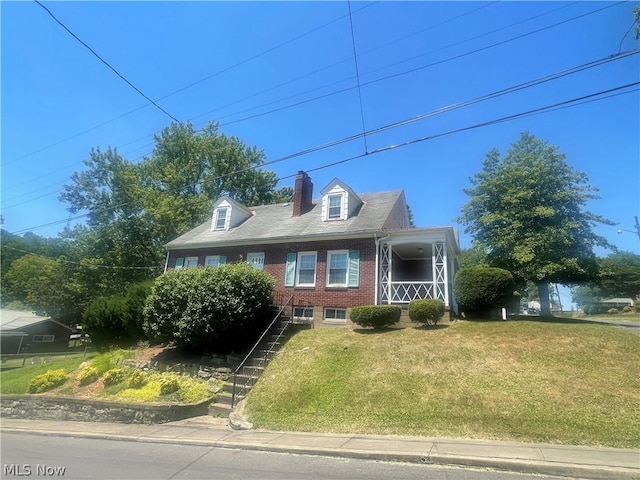 new england style home with a front lawn