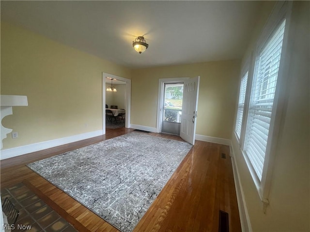 interior space with dark hardwood / wood-style floors and a notable chandelier