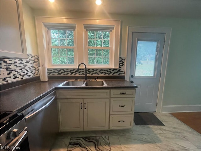 kitchen featuring tasteful backsplash, appliances with stainless steel finishes, and sink