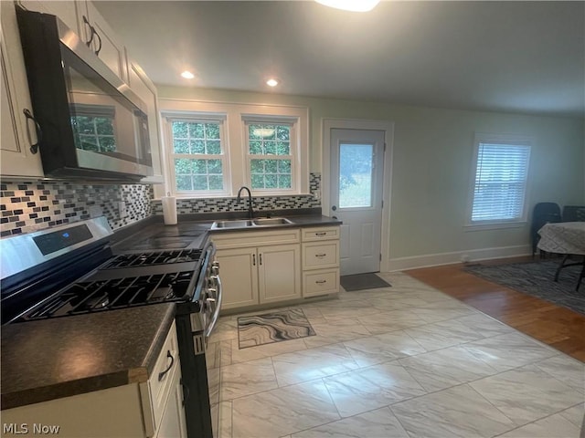 kitchen featuring stainless steel appliances, tasteful backsplash, and sink