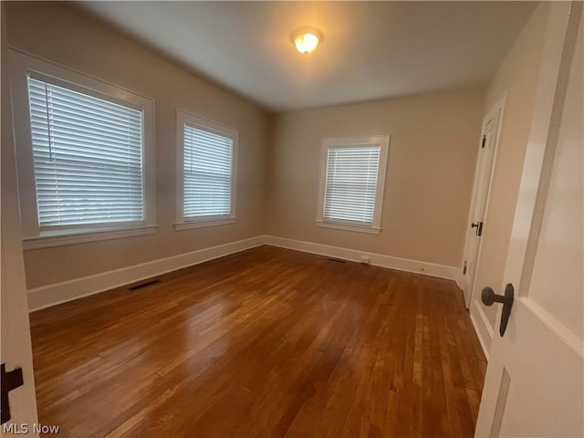 empty room featuring dark wood-type flooring