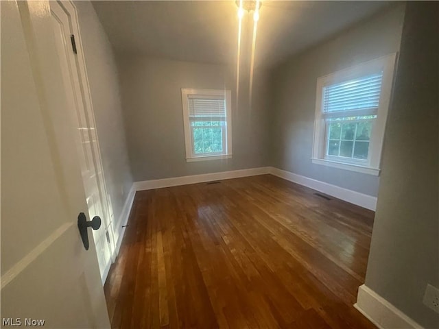 unfurnished room featuring dark hardwood / wood-style floors