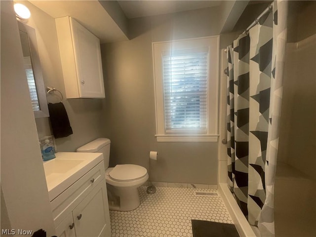 bathroom with vanity, tile patterned floors, toilet, and a shower with shower curtain