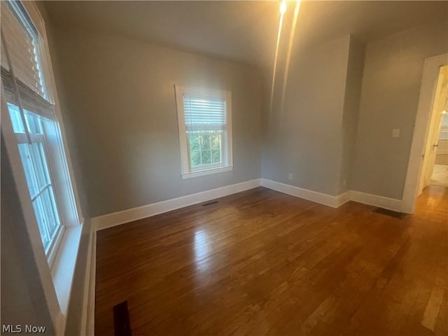 spare room with dark wood-type flooring