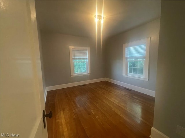 spare room with hardwood / wood-style floors