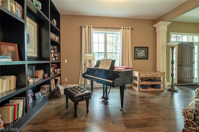 misc room featuring decorative columns and dark hardwood / wood-style floors