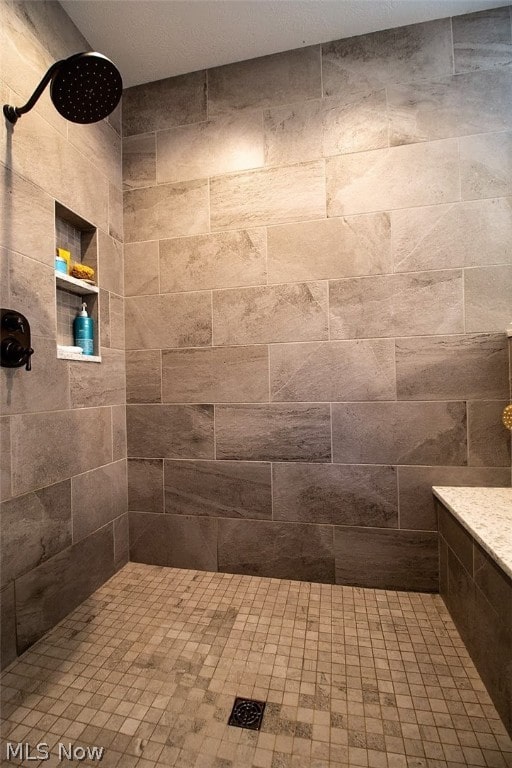 bathroom featuring a tile shower