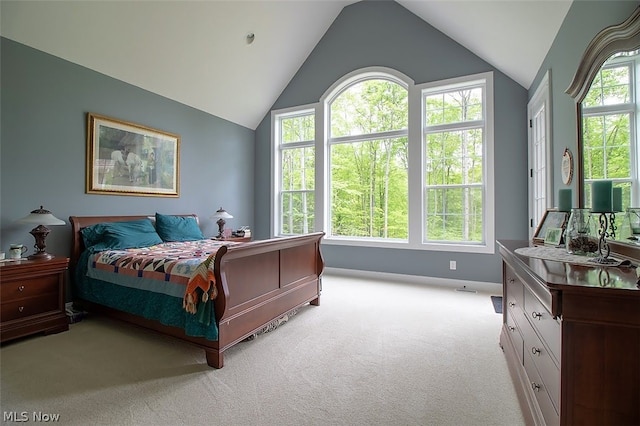 bedroom featuring light carpet, multiple windows, and vaulted ceiling