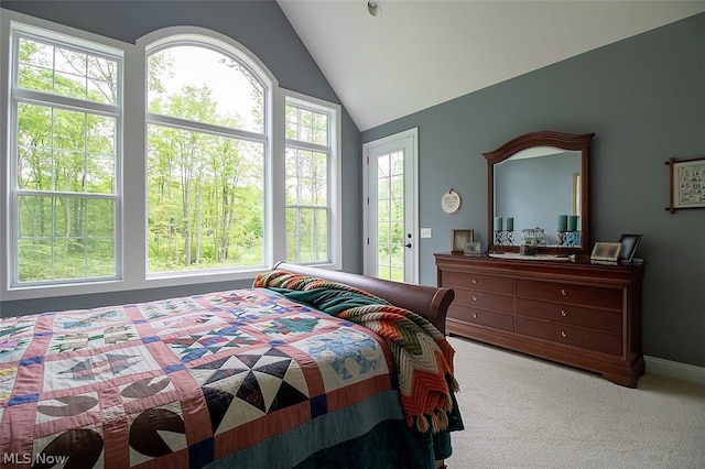 carpeted bedroom with lofted ceiling