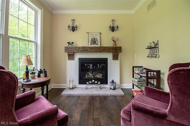 sitting room with a fireplace, dark hardwood / wood-style flooring, and ornamental molding