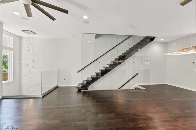 interior space with ceiling fan and dark wood-type flooring