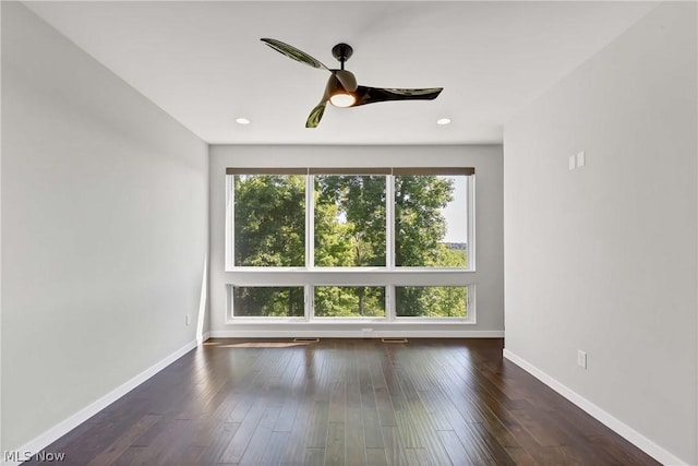 unfurnished room featuring dark wood-type flooring and ceiling fan