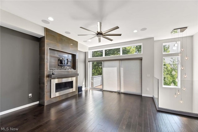 unfurnished living room with ceiling fan and dark hardwood / wood-style floors