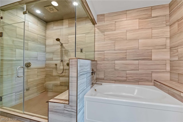 bathroom featuring separate shower and tub