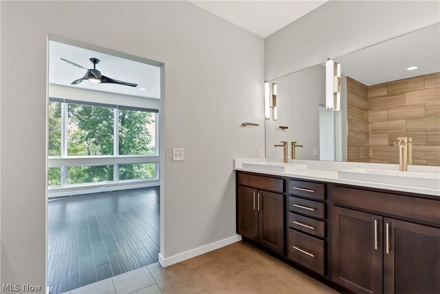 bathroom with double vanity, ceiling fan, and tile floors